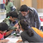 A VITAL volunteer leads BLAST kids in an activity